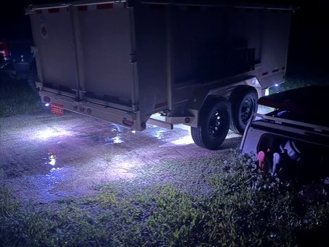 Backroad Hauling dump trailer lit up at night