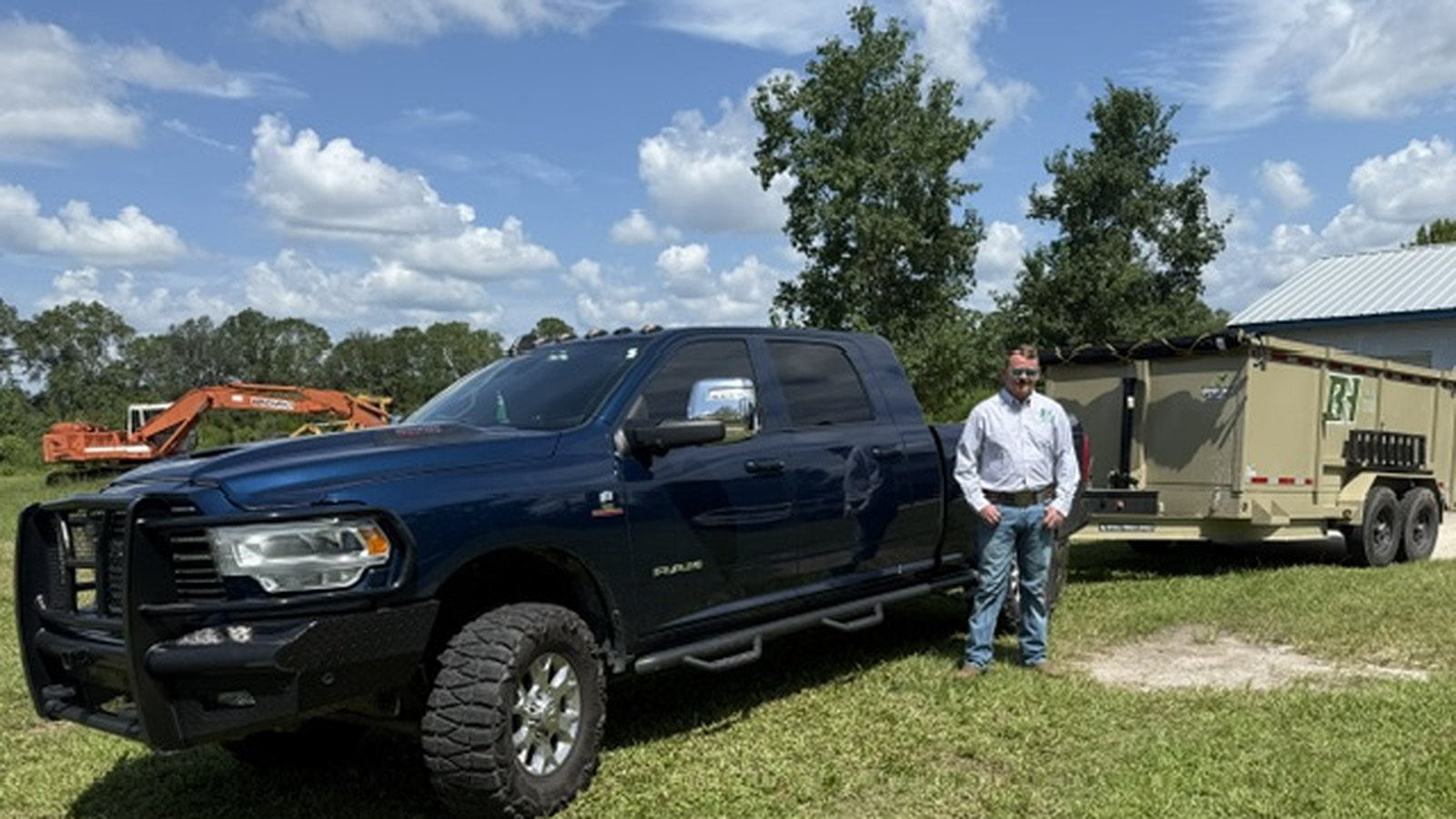 David, owner of Backroad Hauling, with his Ram 2500 and branded 14-foot hydraulic dump trailer in Lawtey, Florida