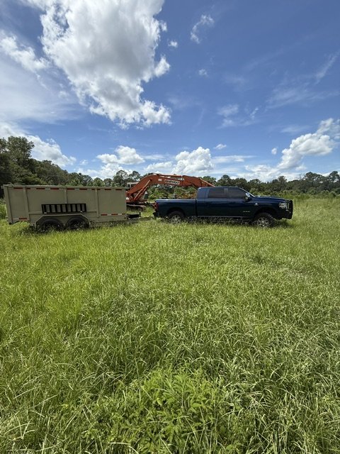 Backroad Hauling truck and dump trailer on a job site in North Florida
